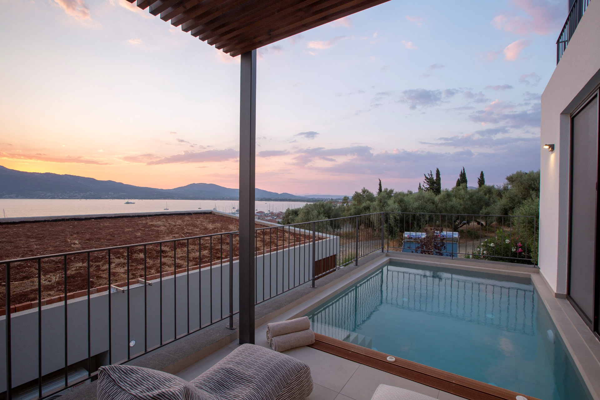 Private plunge pool at dusk with pastel sky over the bay