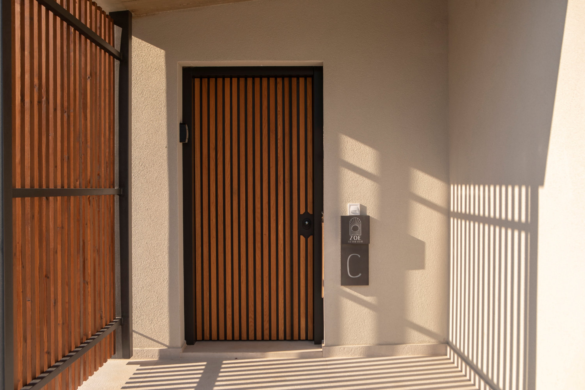 Villa C entrance with slatted timber door and ZOE Sea View Villas sign