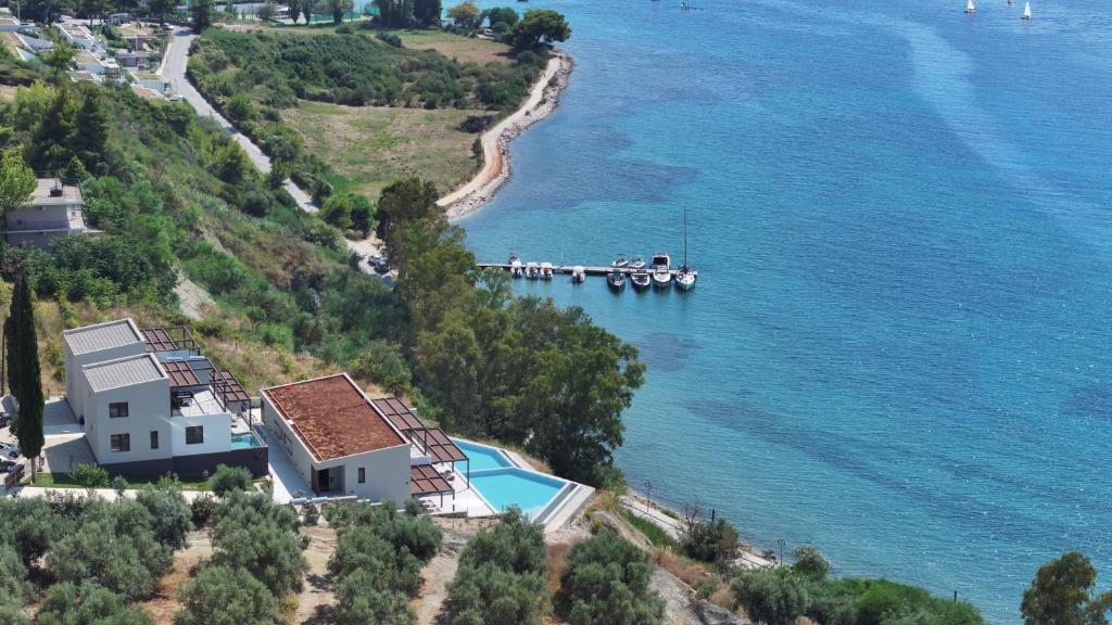 Aerial view of the villas above the turquoise bay and jetty