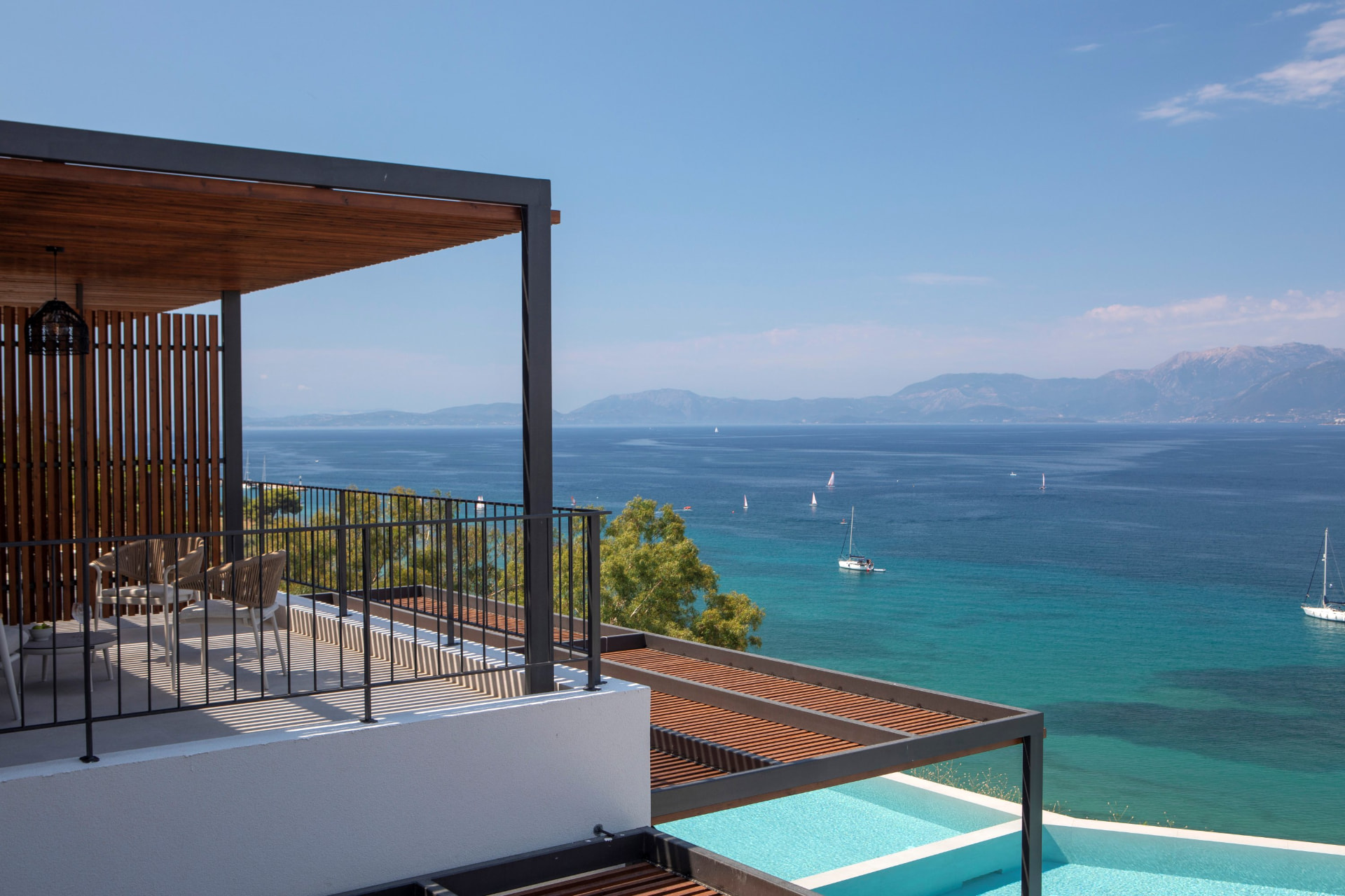 Terrace and pergola above the infinity pools with panoramic Ionian views