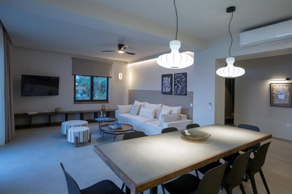 Open-plan living and dining space with pendant lights and white sofa