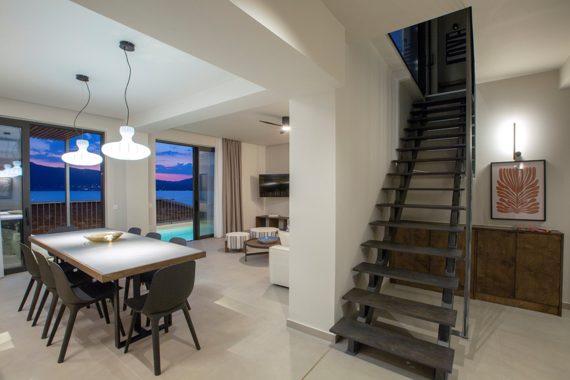 Dining area with staircase and sea views at twilight