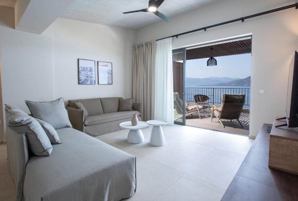 Living room opening onto a sea-view balcony over Paleros bay