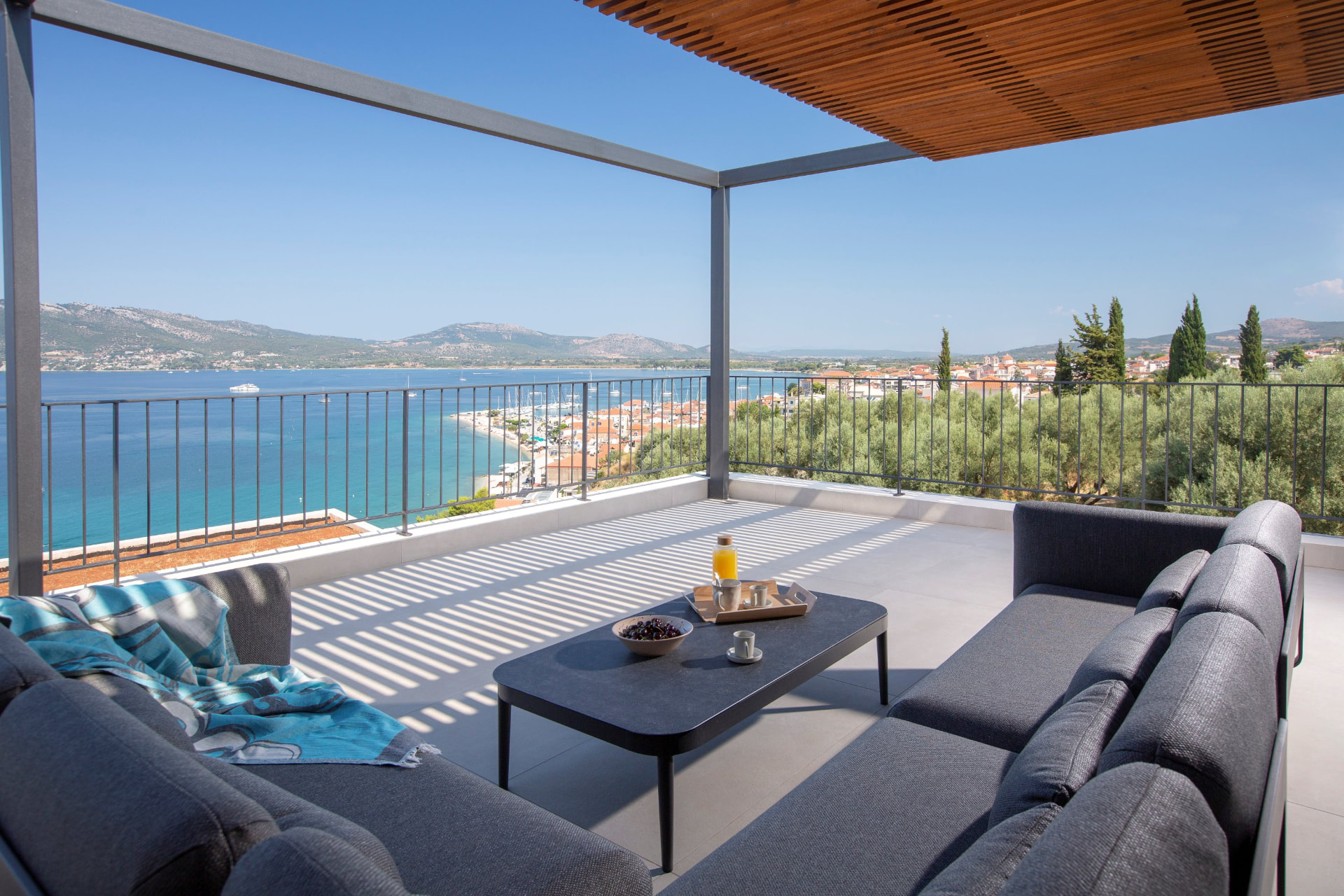 Upper balcony lounge with panoramic view over the bay and village